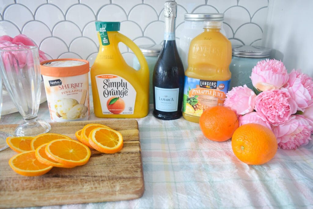 Pineapple Orange Sherbet Mimosa recipe with orange juice, prosecco, pineapple juice, and pineapple sherbet