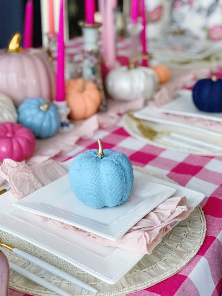 colorful fall tablescape using hot pinks apricot orange and french blue color palette pink gingham tablecloth and pink taper candle centerpiece