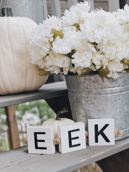 eek block white pumpkins and white mums for halloween porch