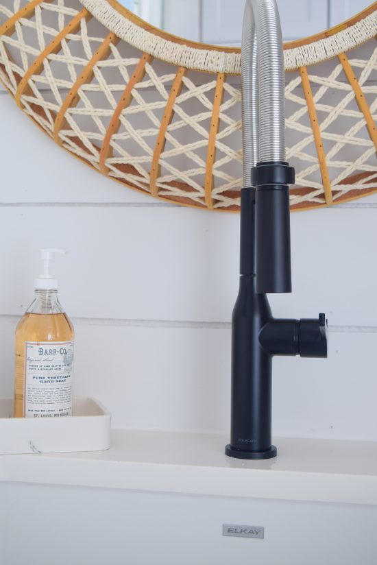 matte black faucet with shiplap walls 