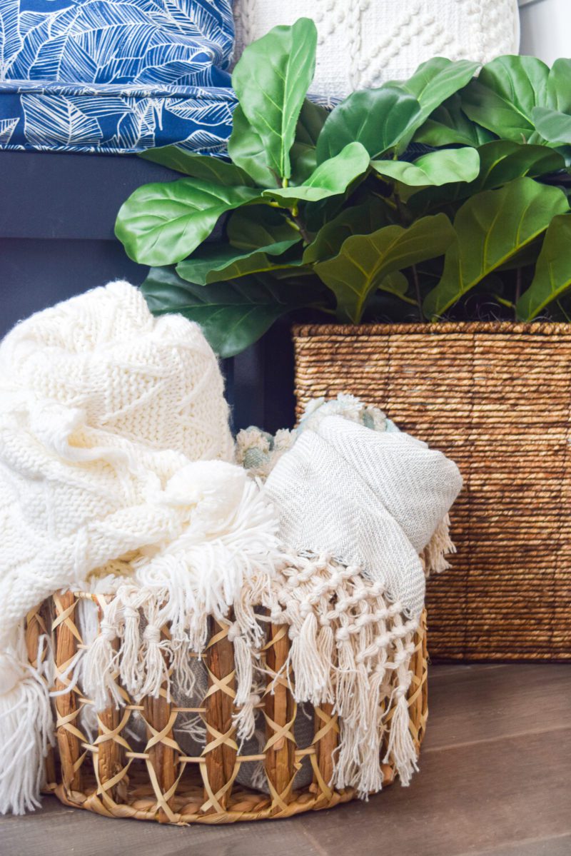 blankets in woven basket and spring plant