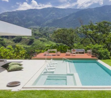 rectangle pool with in level spa and light blue water